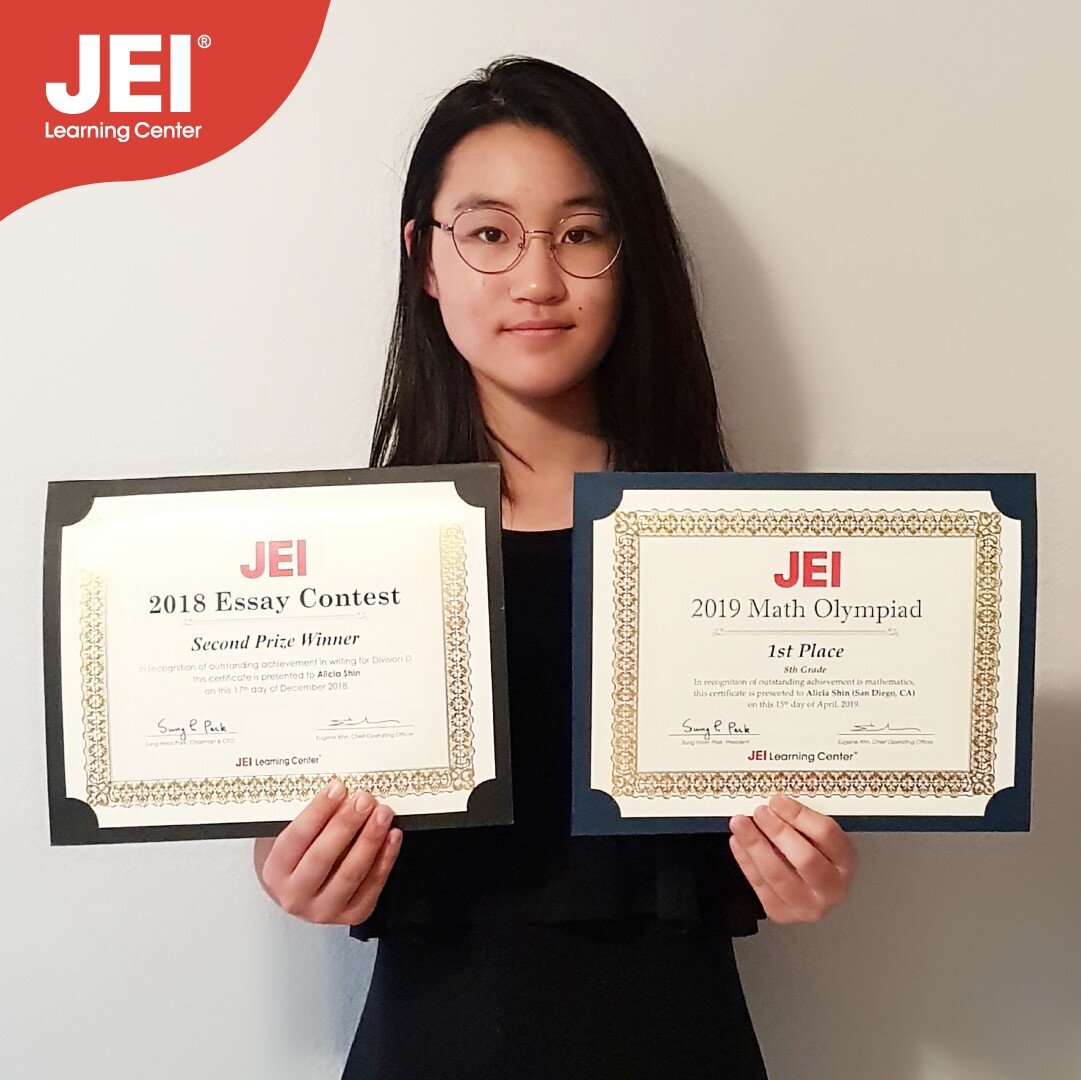 vertical photo of Alicia Shin holding her 2019 Math Olympiad and 2018 Essay Contest winning certificates.